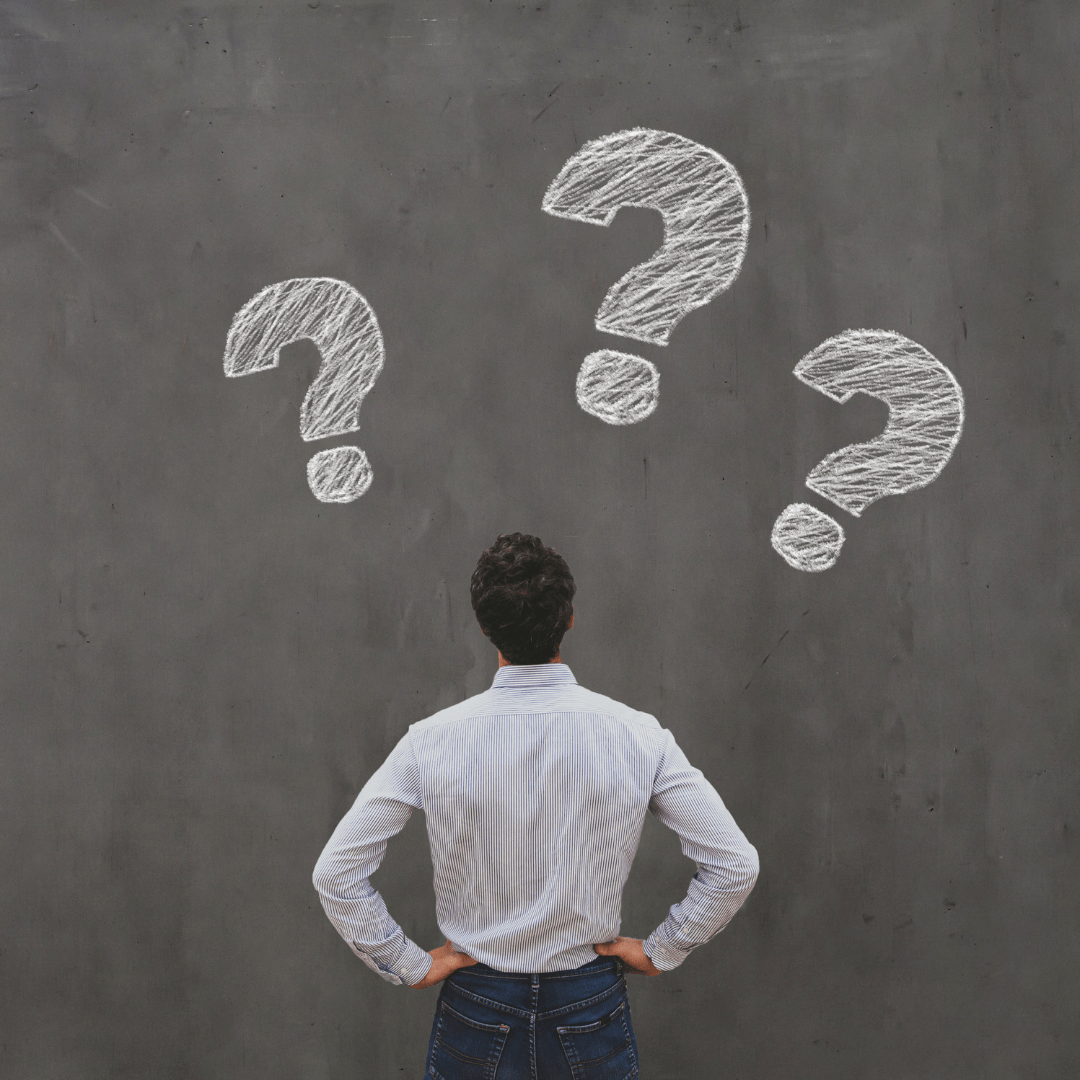 Business professional facing question marks, representing the decision between choosing an MSP or MSSP
