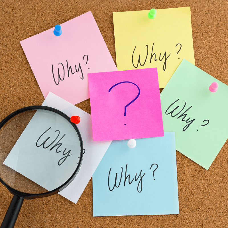 Colorful sticky notes pinned to a corkboard, each labeled “Why?” with a magnifying glass emphasizing one, symbolizing questioning, strategy review, and deeper investigation.