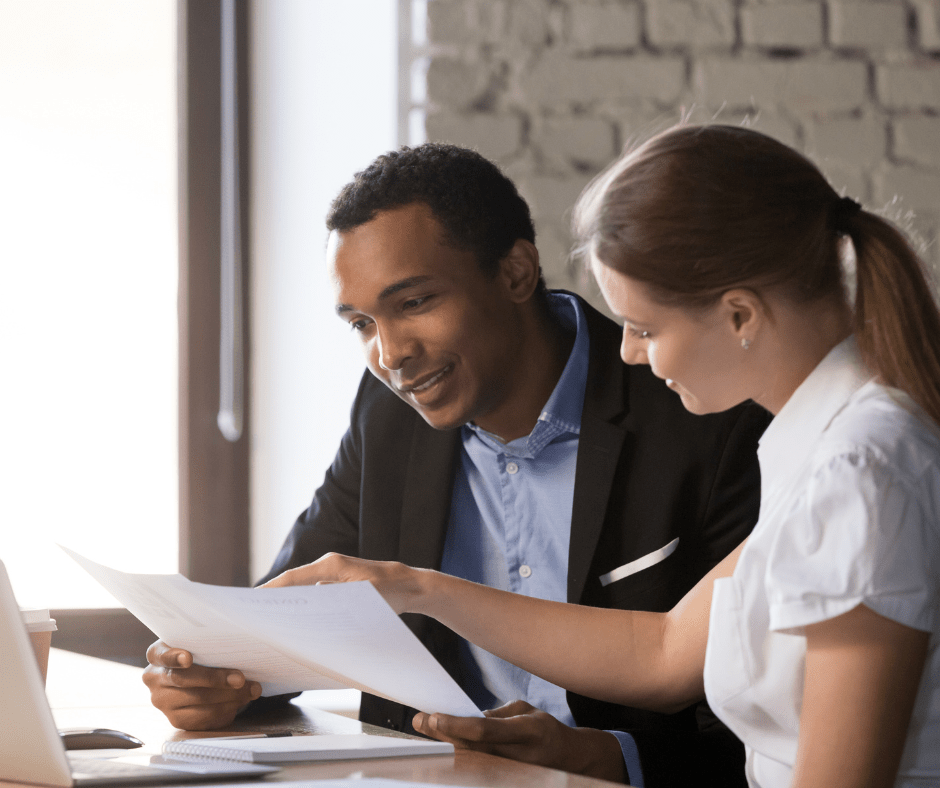 Business consultant reviewing cybersecurity readiness documents with a client