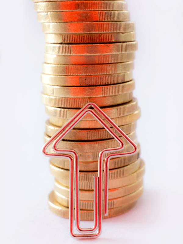 Stack of gold coins with upward arrow symbolizing rising costs from being unprepared